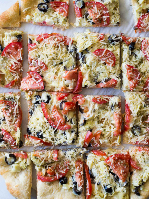 overhead shot of artichoke pizza cut into pieces