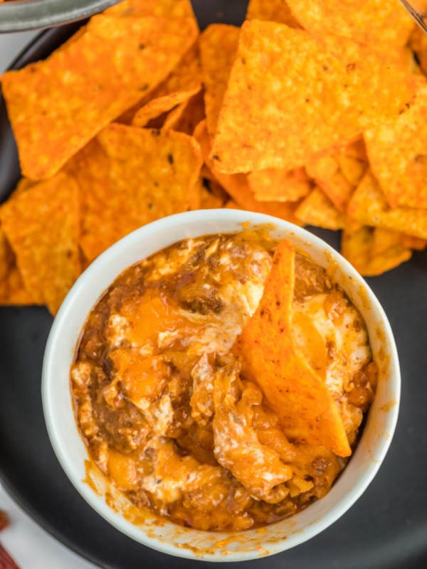 chili cheese dip in a bowl with chips