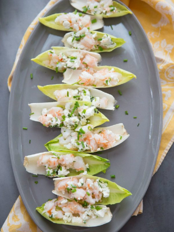 endive with shrimp salad on a gray platter