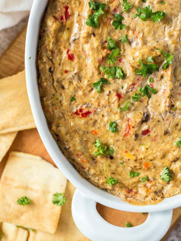 hot artichoke dip in a white baking dish