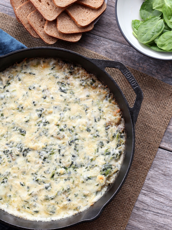 hot spinach artichoke dip in a cast iron skillet