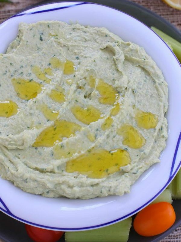 hummus with olive oil drizzled on top in white bowl