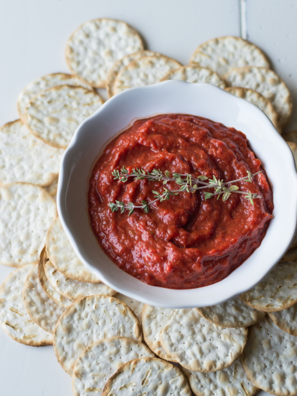 roasted sweet red pepper spread in white dish with crackers