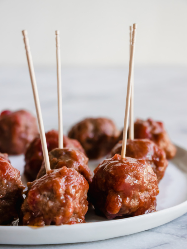 sweet and sour meatballs on a plate with toothpicks