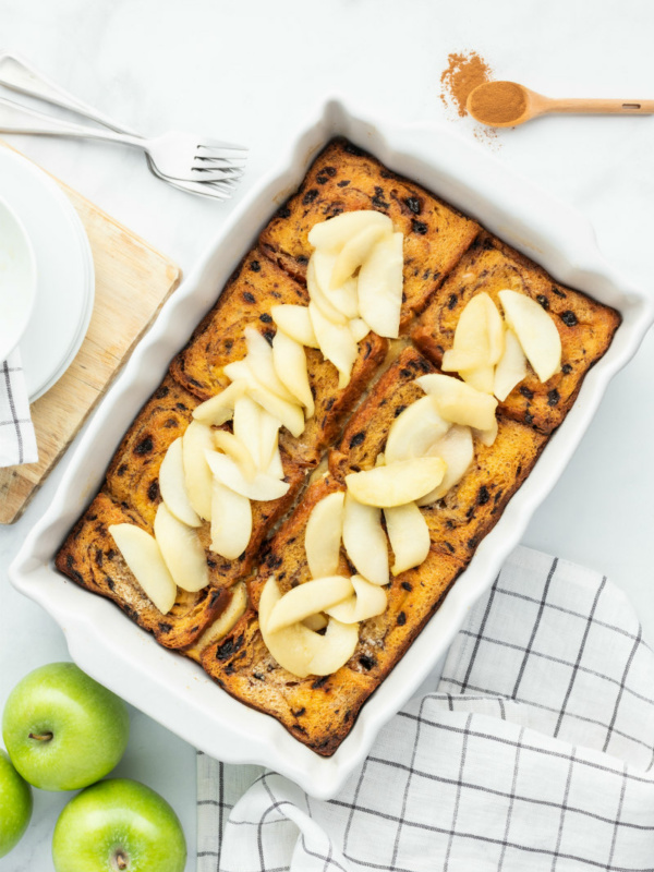 overnight apple stuffed french toast in a white casserole dish