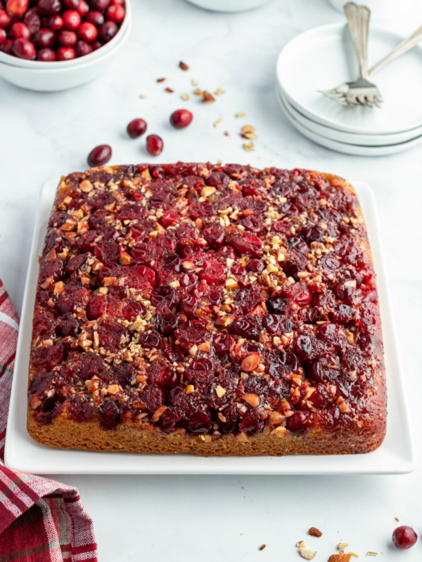 pumpkin cranberry upside down cake on white platter