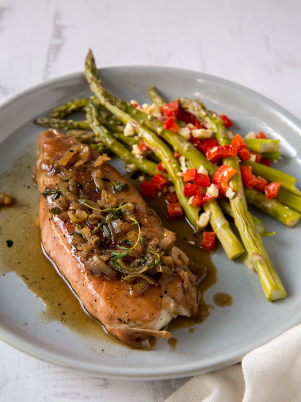 prosciutto roasted halibut on plate with asparagus