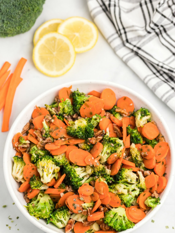 bowl of sauteed broccoli with carrots and pecans