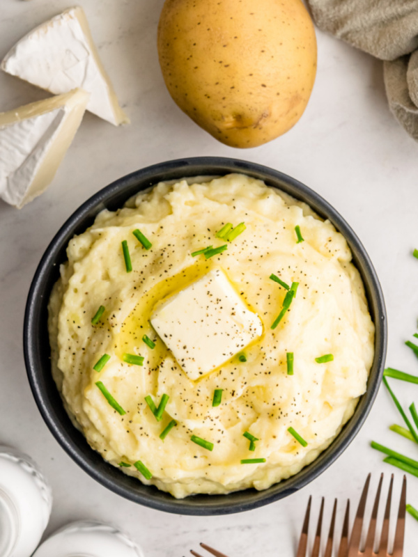 camembert mashed potatoes in a bowl with a pat of butter