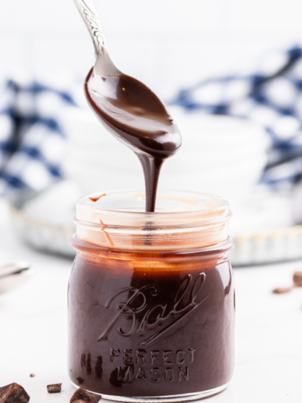 spooning fudge sauce out of jar