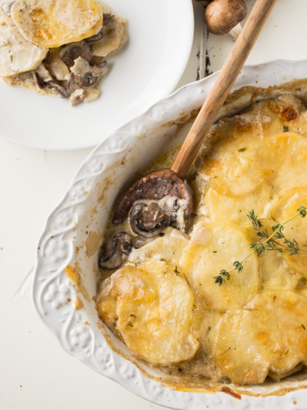 mushroom potato gratin with a wooden spoon