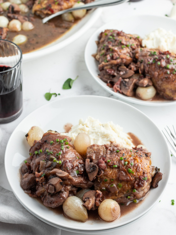 serving of coq au zin on white plates