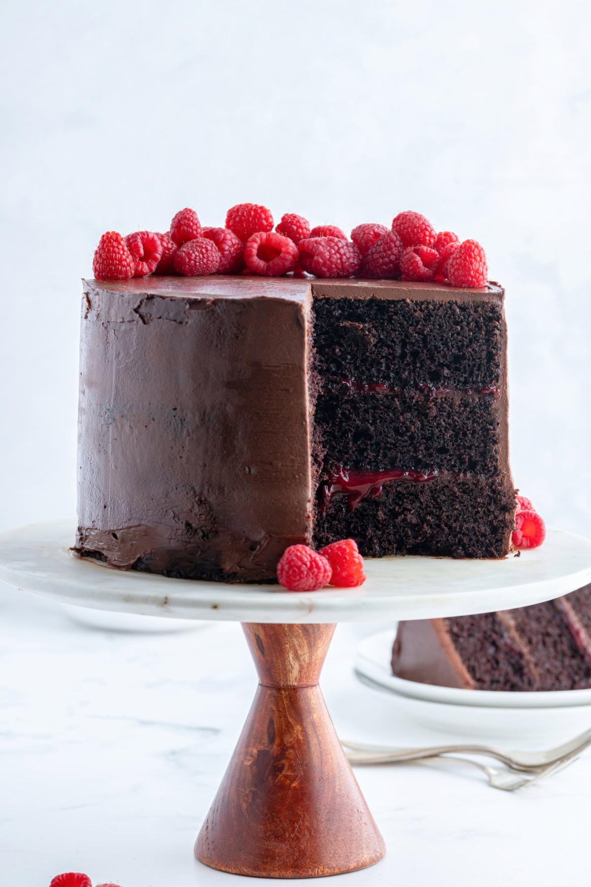 double chocolate cake with raspberry filling with big slice taken out of it