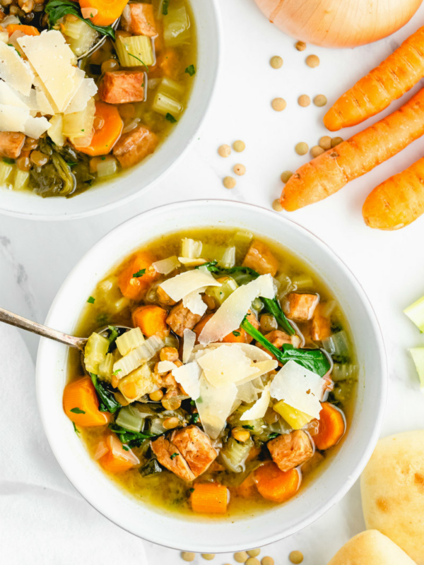 ham and lentil soup with spoon in white bowl