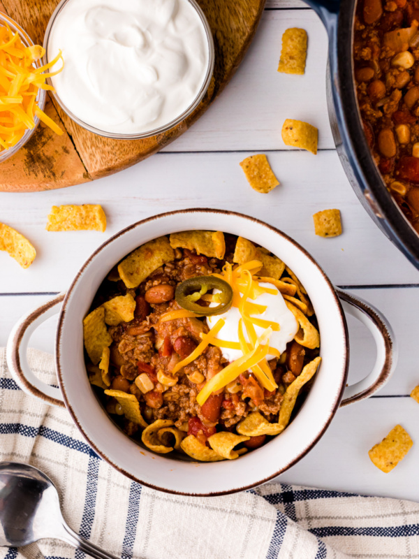 taco soup in a bowl topped with sour cream and shredded cheese