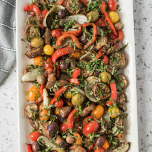 overhead shot of grilled vegetable salad on a rectangular white platter