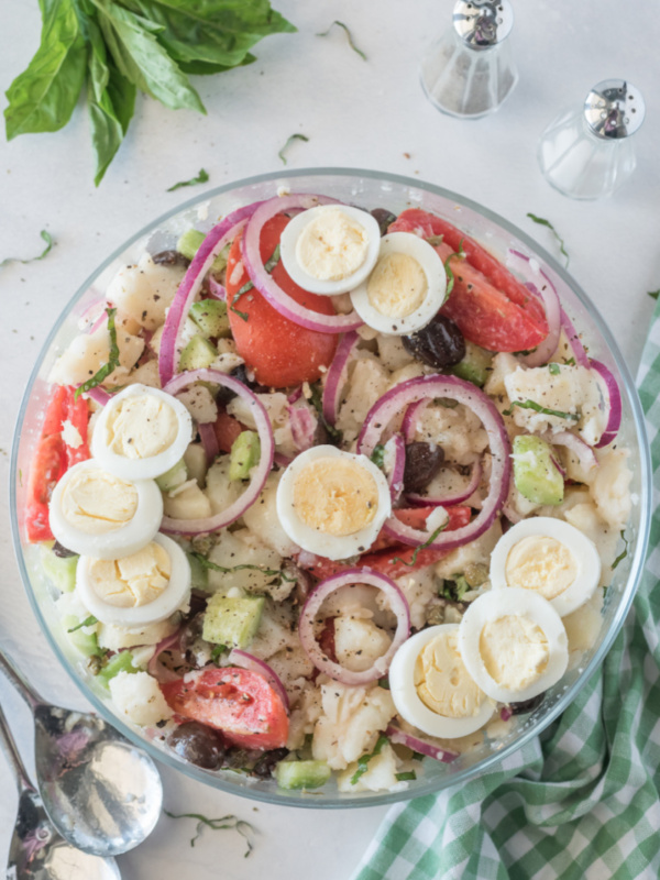 bowl of potato salad with olives tomatoes and capers