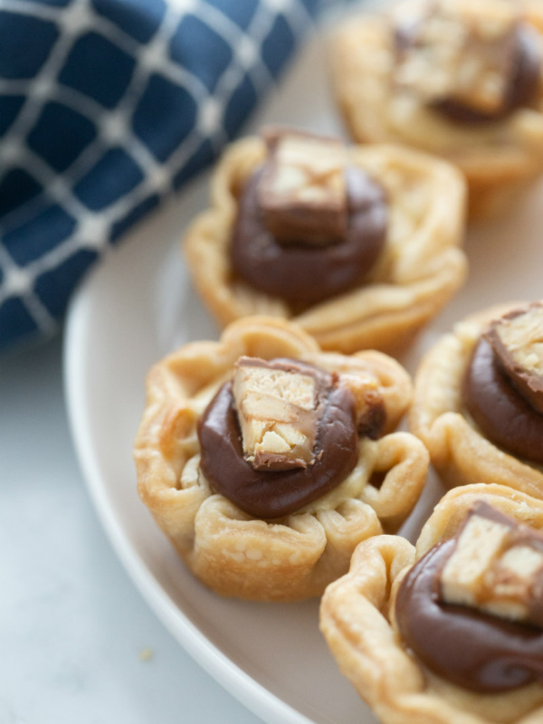 snickers bar mini tarts on a white platter