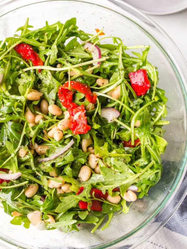 arugula, white bean and roasted red pepper salad in a bowl