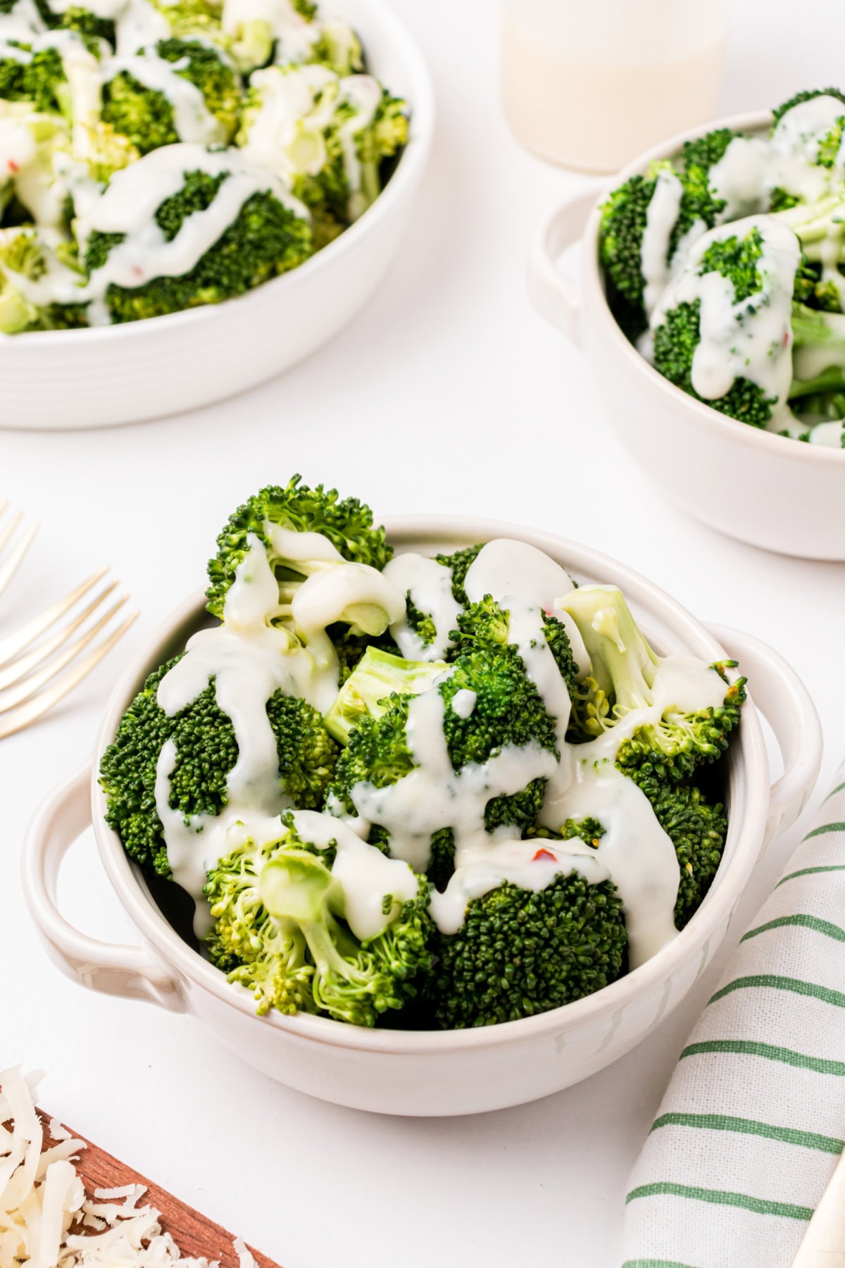 bowl of broccoli with two cheese sauce