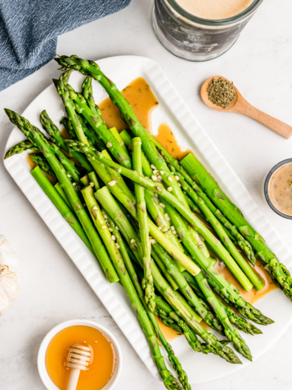 drunken asparagus on a white plate