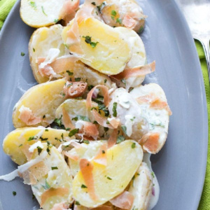 fingerling potato and prosciutto salad on a blue plate