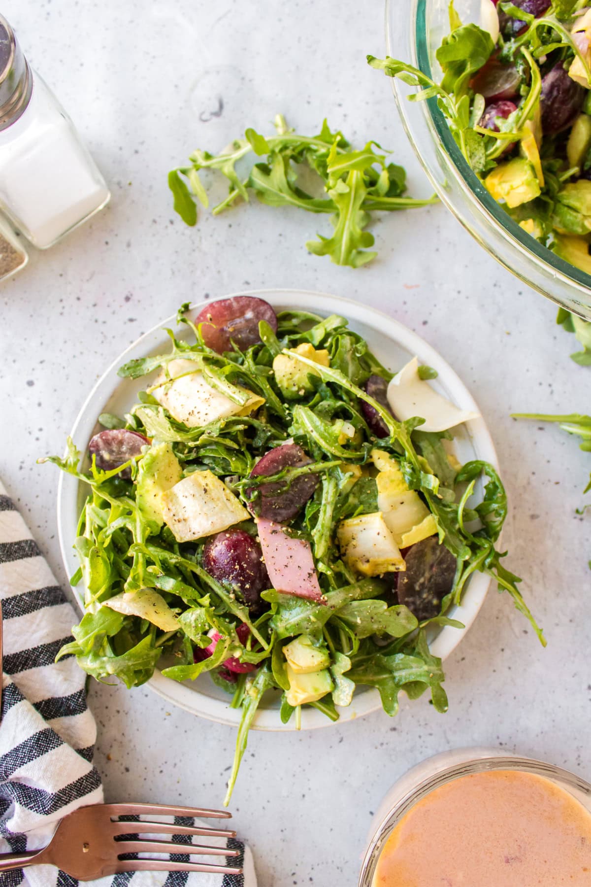 overhead shot of serving of grape avocado and arugula salad