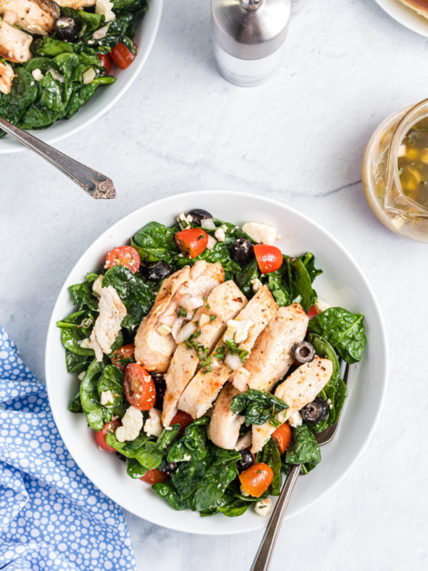 plate of spinach salad with chicken