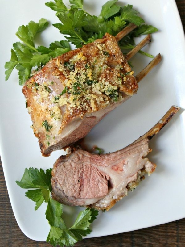 panko crusted rack of lamb cut and on plate with parsley