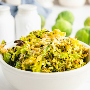 shredded parmesan brussels sprouts in white bowl