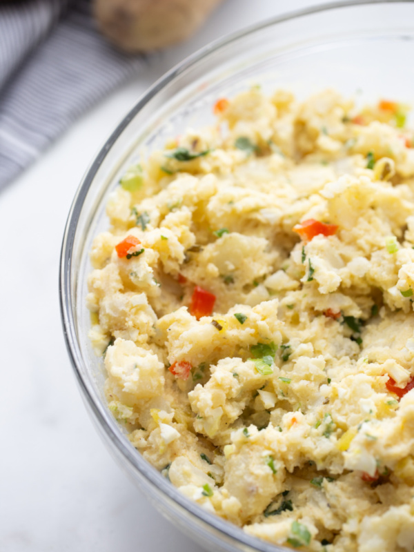 smashed potato salad in a glass bowl