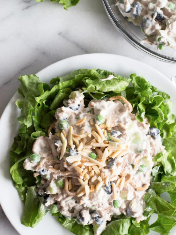 tuna salad on a bed of lettuce on white plate