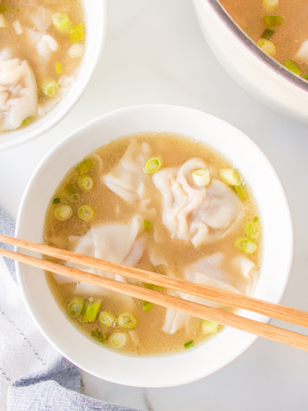 bowl of wonton soup with chopsticks