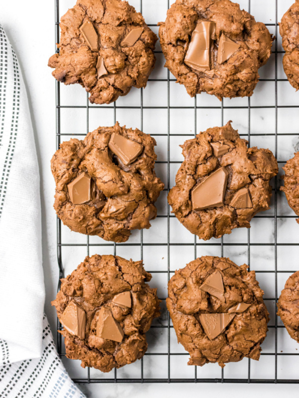 triple chocolate chunk cookies on a cooling rack