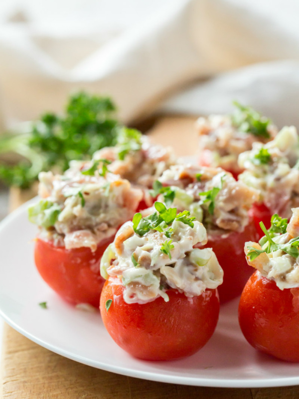 bacon stuffed cherry tomatoes on a white plate