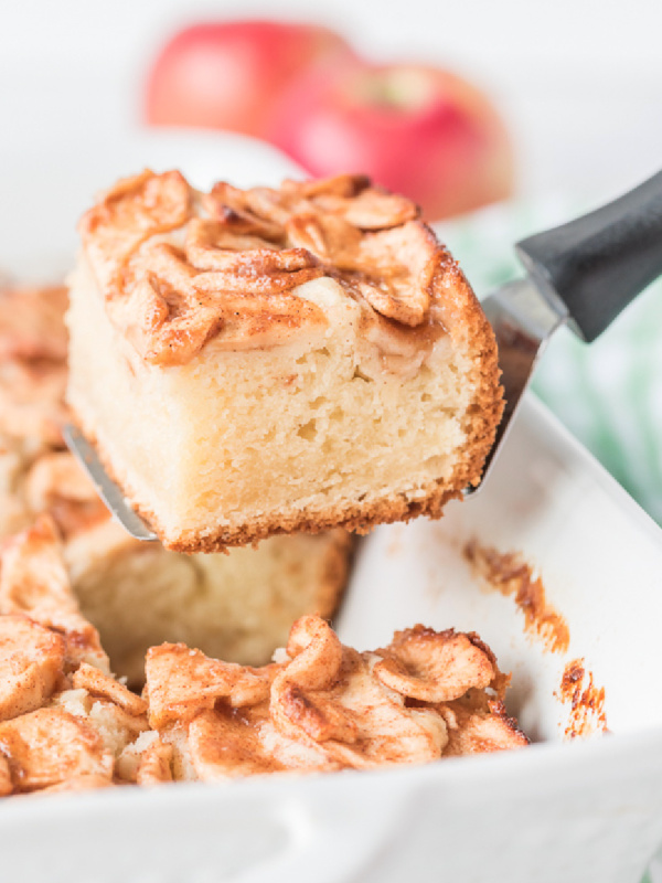 spatula taking out slice of apple coffee cake out of pan