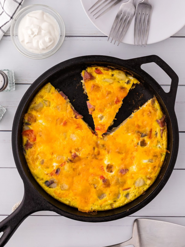 o'brien frittata in cast iron skillet with slice cut