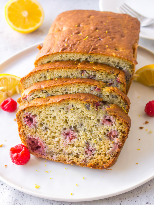 raspberry lemon loaf on plate cut into slices