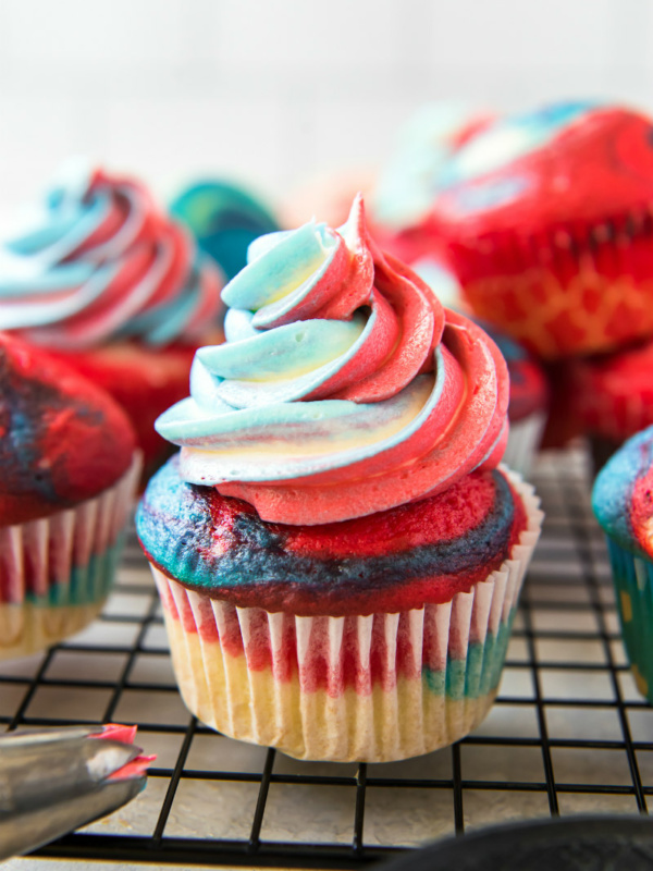 red white and blue cupcakes on a cooling rack