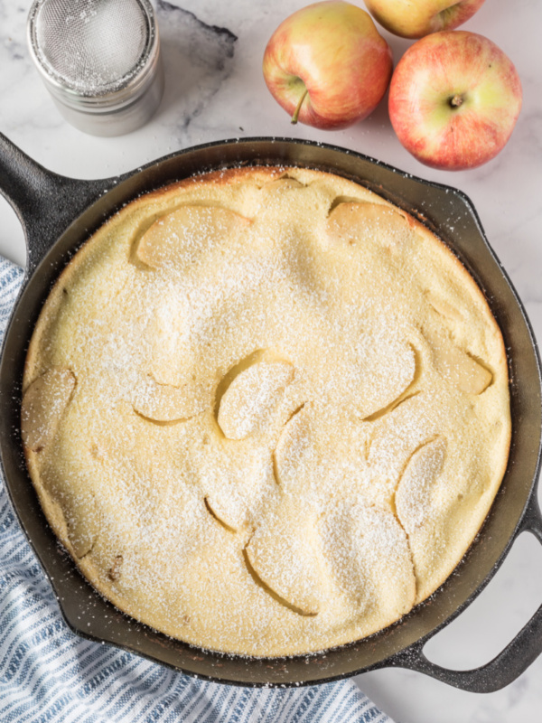 big apple pancake in a cast iron skillet