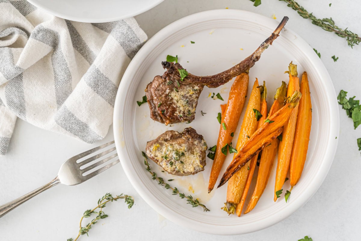 broiled lamb chops on plate with carrots