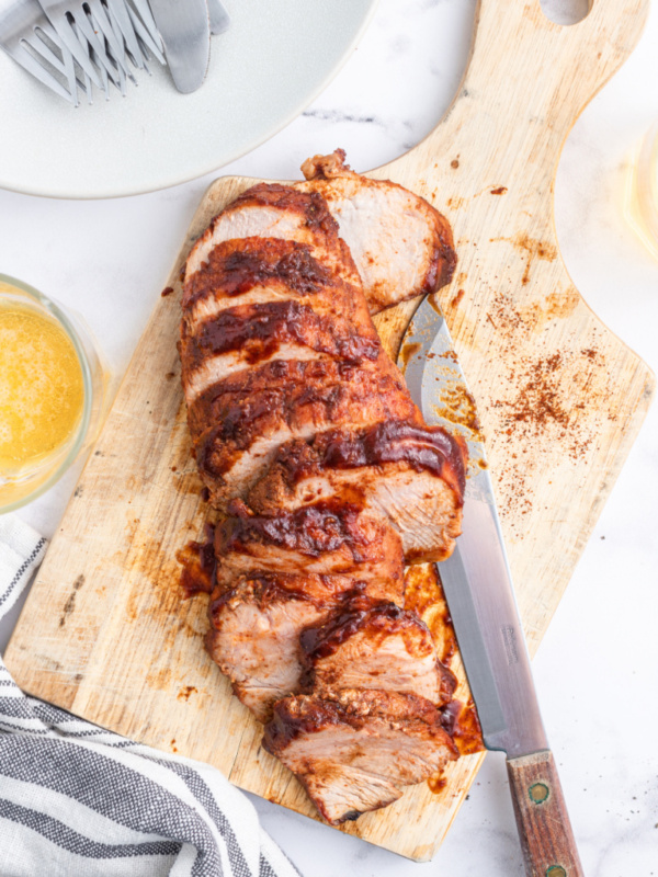 sweet and tangy roasted pork tenderloin sliced on board