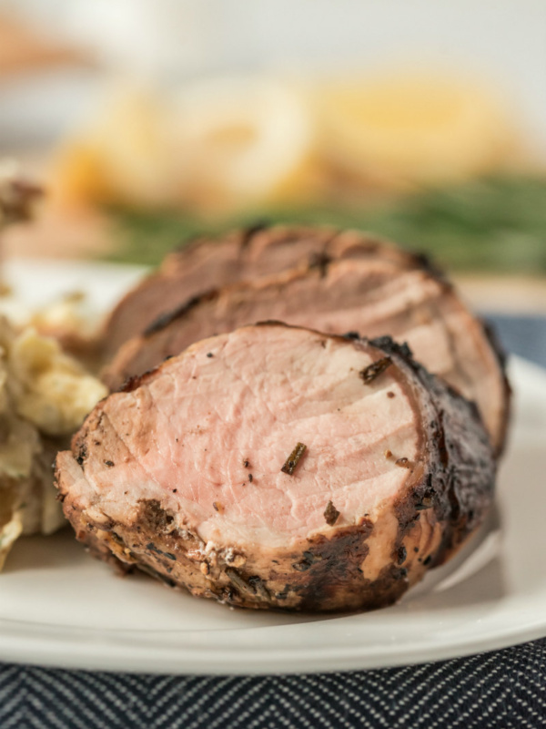 sliced grilled pork tenderloin on a white plate