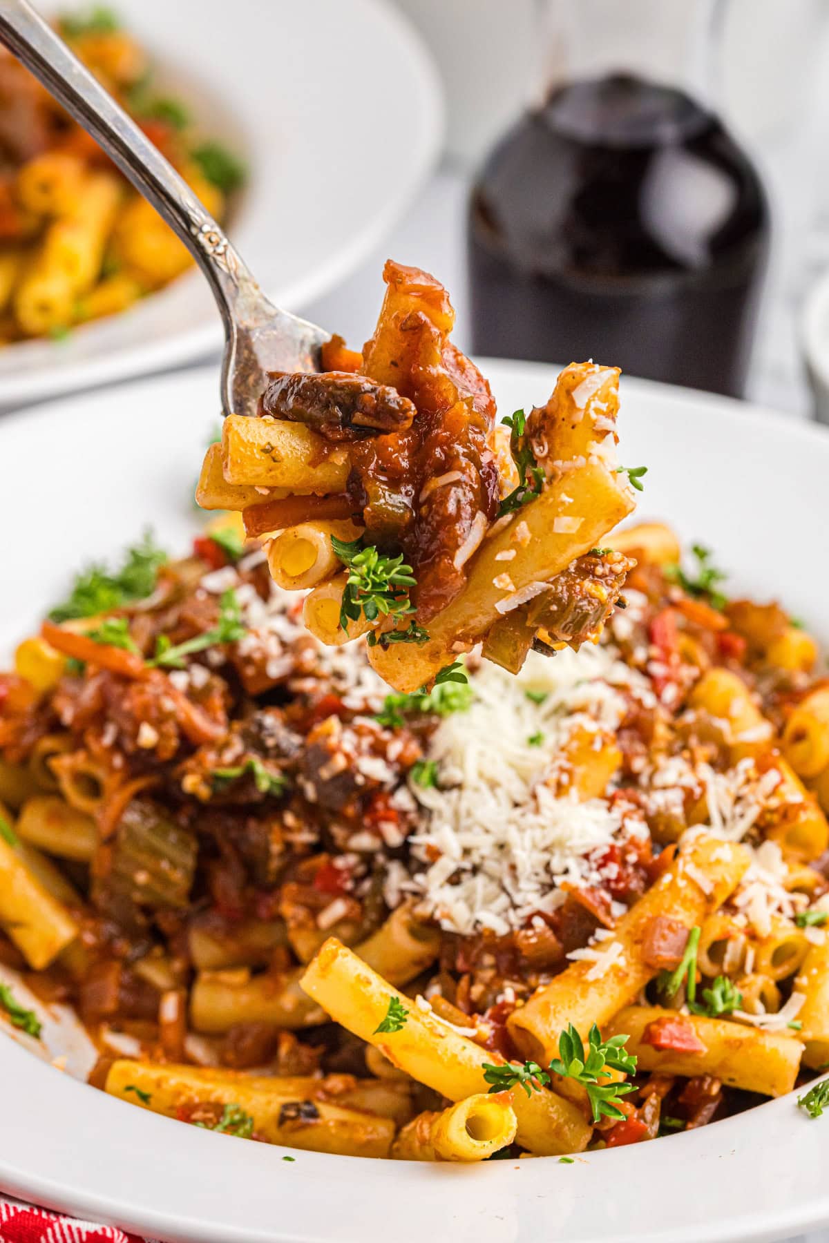 fork into bowl of pasta with garden bolognese