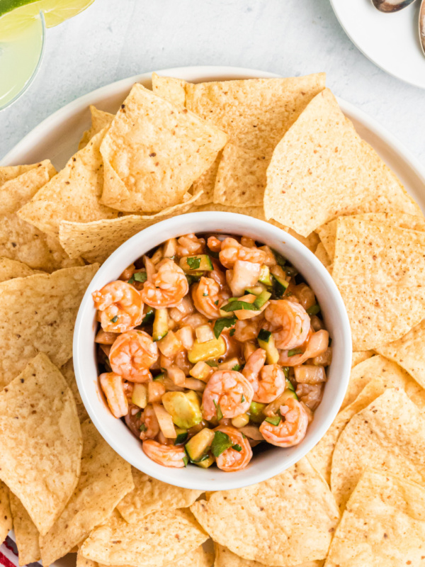 shrimp ceviche in a bowl surrounded by tortilla chips