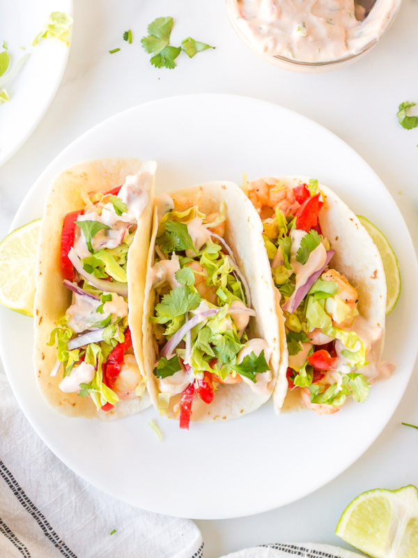 three tacos on a white plate