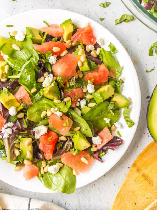 watermelon and avocado salad on a white plate