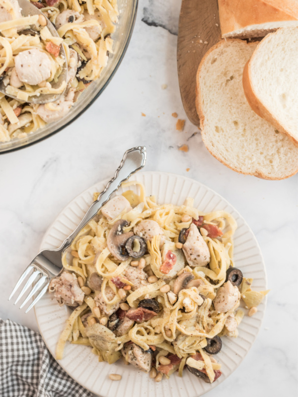 serving of pasta on white plate with fork