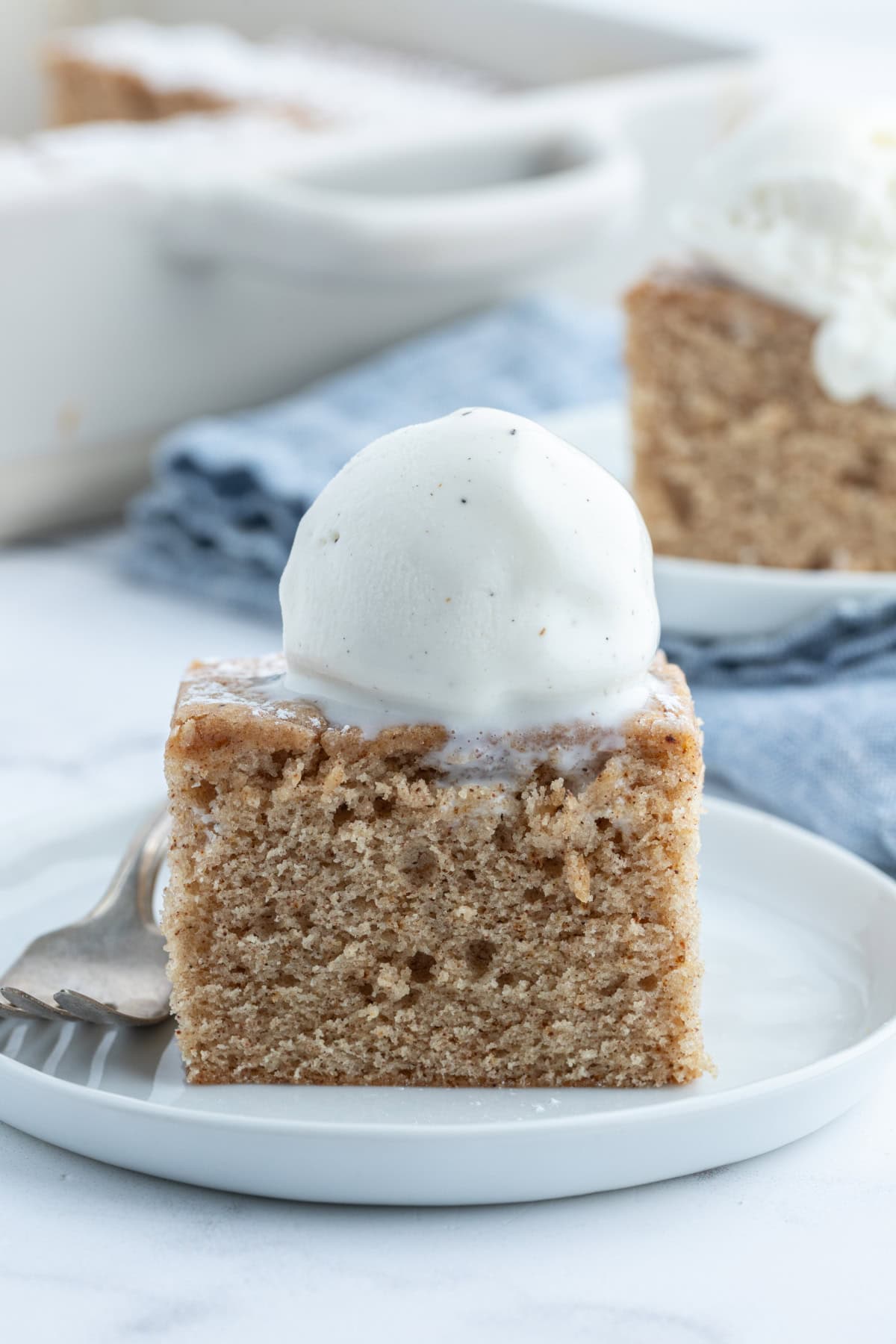 slice of ginger spice cake with ice cream on top