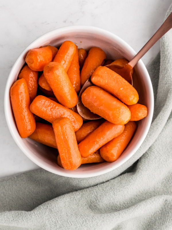 bowl of glazed carrots with a spoon